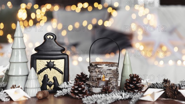 Christmas or New Year composition with various home decorations, different symbolic toys composed and ordered at coffee table with blurred Christmas lights background at sofa white cover. Family time
