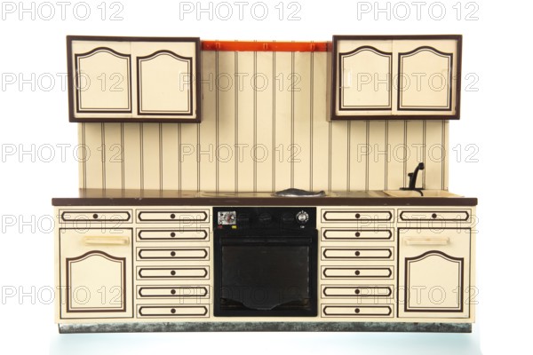 Miniature vintage toy kitchen isolated over white background