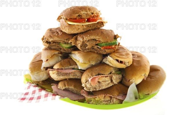 Many bread rolls with meats and cheese
