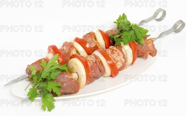 Prepared food for barbecue (shish kebab) - seasoned meat with vegetables on skewers