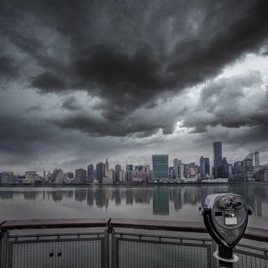 Manhattan New York cloudy dramatic skyline sunset from East River dusk USA