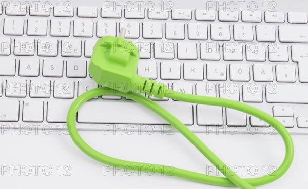 Green power plugon a keyboard isolated on white background
