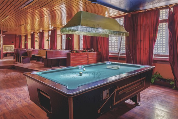 A room with a pool table in the centre, red curtains and a wooden ceiling, Bad am Park, Lost Place, Essen, North Rhine-Westphalia, Germany, Europe