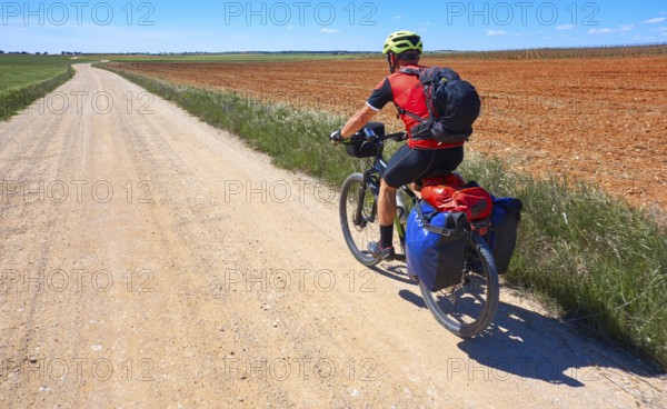 Biker pilgrim by Camino de Santiago in bicycle at Saint James Way of Levante