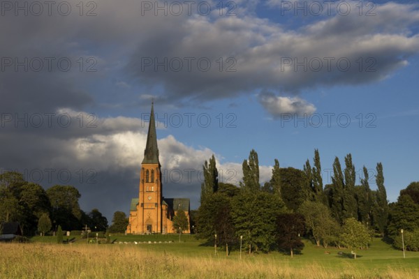 Undenas church in the Swedish village Undenas lights up in the last rays of sunlight