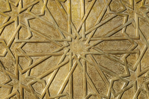 Artistically designed portal Dar el-Makhzen Place des Alaouites Fes El-Jdid, entrance area of the royal palace, close-up of a golden relief with complex geometric patterns and arabesques, Northern Morocco, Morocco, Africa