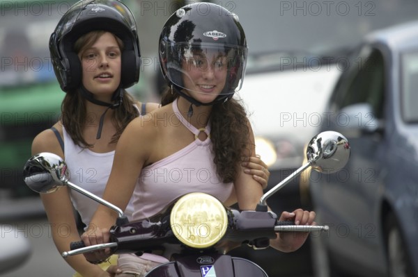 Two woman riding a scooter, Barcelona, Spaina