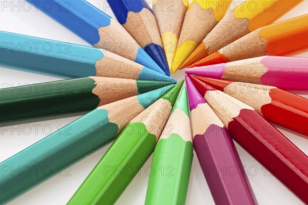 Lots of different coloured pencils on a white background
