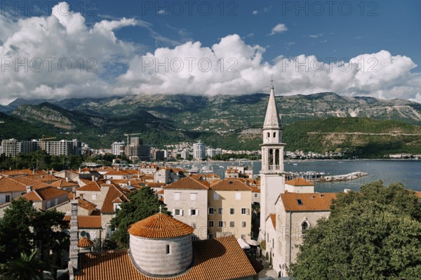 Church of the Holy Trinity near St. John Cathedral among old houses with red roofs. Budva, Montenegro.