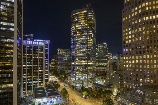 Cityscape at night with illuminated skyscrapers and modern style streets, Vancouver, British Columbia, Canada, North America
