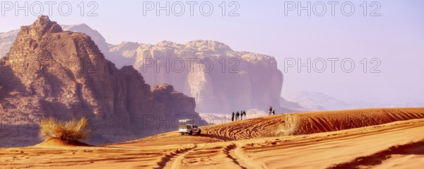Jordan, Wadi Rum, November 2, 2022: Jeep safari in desert. Tourists and off-road car trace on dune sand and the beautiful rocks landscape, Asia