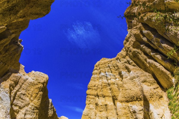 Scenic Clay Cliffs. Bright blue sky above the tops of picturesque rocks. Travel to New Zealand. The concept of active, eco and photo tourism