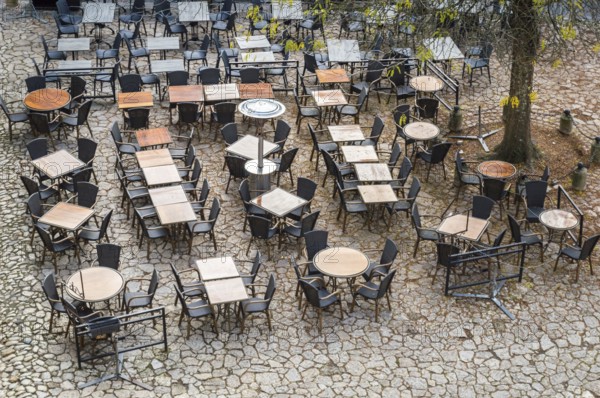 View from above outdoor empty tables and chairs of cafe in France