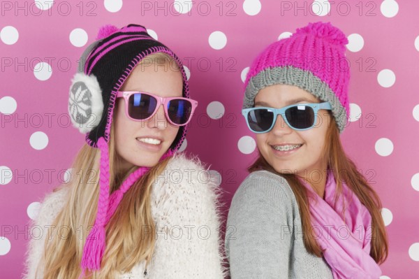 Two fourteen years old teens as girlfriends in winter