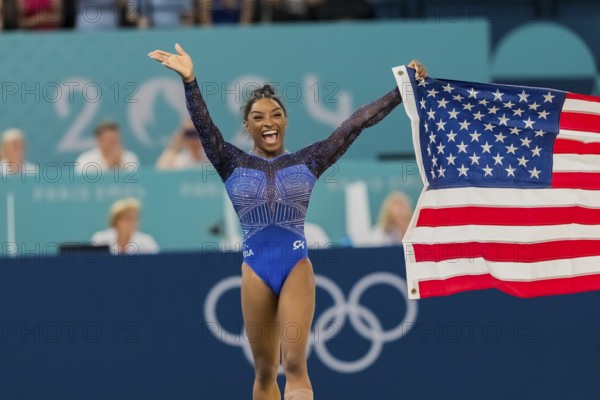 Simone Biles (USA) of the United States celebrates with the fans after winning the Artistic Gymnastics Women's All-Around Final at the Bercy Arena during the 2024 Paris Summer Olympics in Paris, France. (persons) of (persons)#4, competes in the Women's All-Around Finals at the Bercy Arena during the 2024 Paris Summer Olympics in Paris, France, Europe