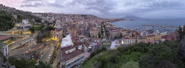 Panorama of Naples with the Gulf and the famous Vesuvius in the clouds after sunset