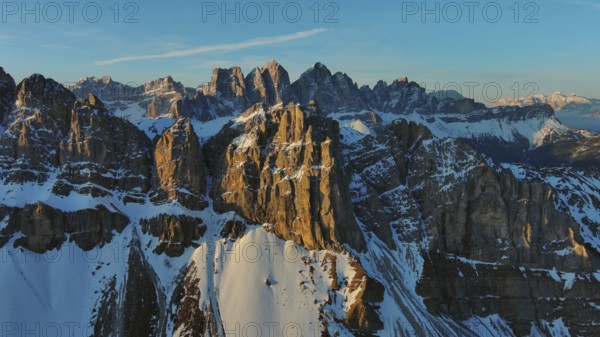 Aerial view of amazing rocky mountains in snow at sunrise, Dolomites, Italy, Europe