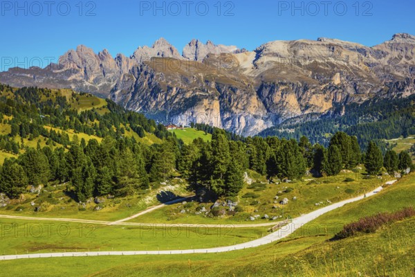 Windy sunny autumn day. Travel to South Tyrol, Dolomites. The concept of extreme and ecological tourism. The picturesque road on the Sella Pass