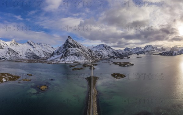 Fredvang Bridge, Car and Volandstind Mountain in Winter. Flakstadoya, Lofoten Islands, Landscape of Norway. Aerial View