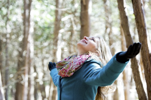 Blond casual woman happy outdoors in the woods, Toronto, Canada, North America