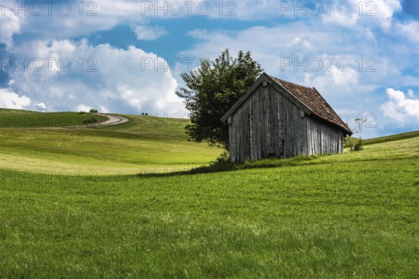 Scenic view over the German countryside around the village Kappel with two old wooden sheds over the green hills