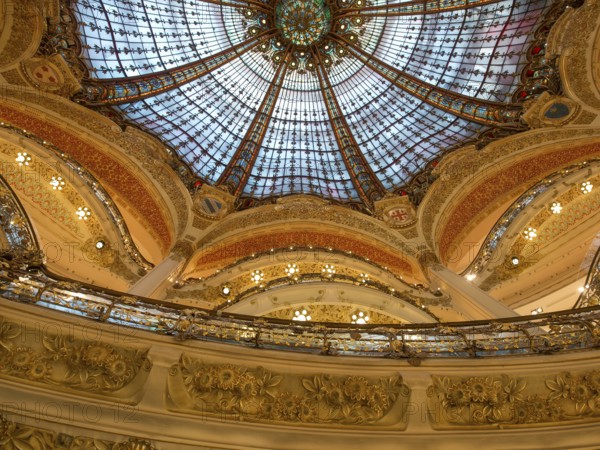Magnificently decorated dome with colourful stained glass windows that shine in golden light, rich in architectural details, paris, france