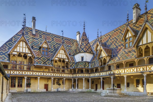 Hospices de Beaune or Hotel-Dieu de Beaune is a former charitable almshouse in Beaune, France. Courtyard, internal facade with polychrome roof
