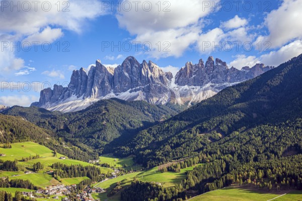 Charming old little church in the Val de Funes. Dolomites on a sunny autumn day. The beautiful village in the Dolomites Santa Maddalena
