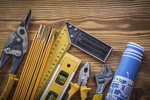 Composition of building tools on vintage wooden board top view