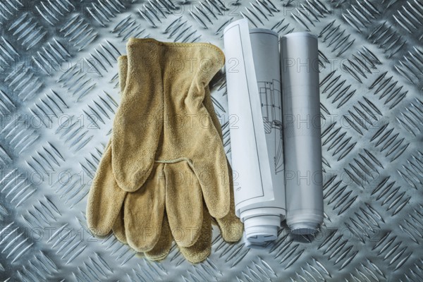 Construction drawings safety gloves on channeled metal sheet