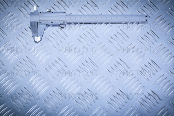 Vernier caliper on grooved metal plate construction concept