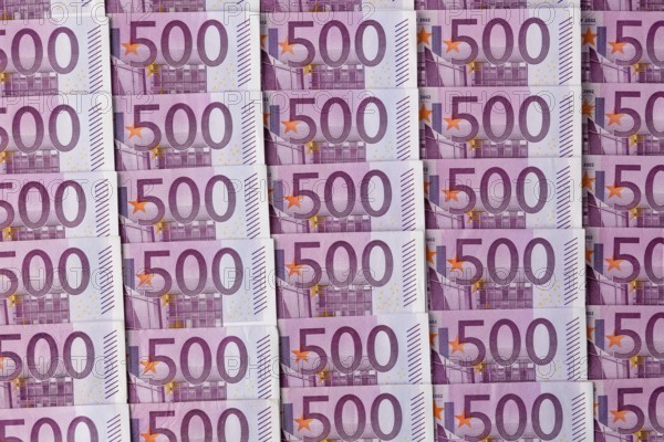 Many five hundred euro banknotes lying next to each other. Symbolic photo for wealth and investment Austria