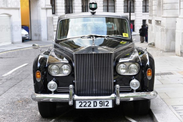 London, London Region, England, United Kingdom, Europe, Black luxury car with shiny finish in a city street, Europe