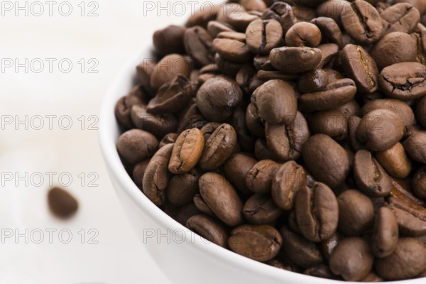 Bowl of caffee beans on a white background