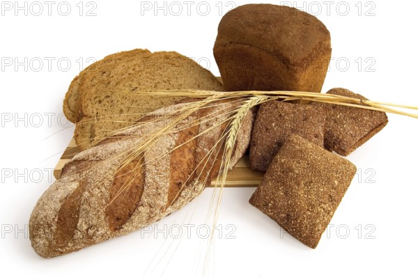 Various rye bread with a wooden board with stems of rye isolated on a white background, Russia, Europe