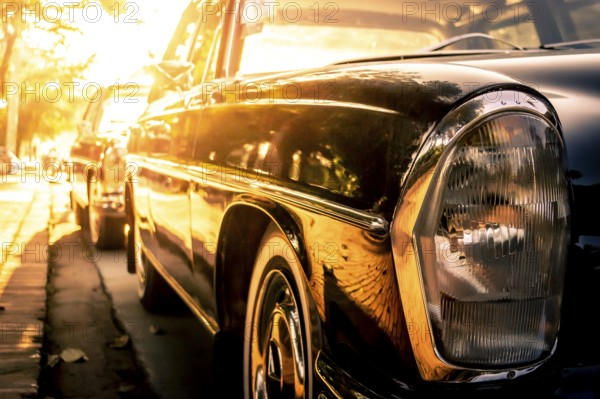 Side view of a Mercedes Benz W114, /8, stroke eight or Strich Acht, parked in the streets of Luang Prabang during golden hour or sunset