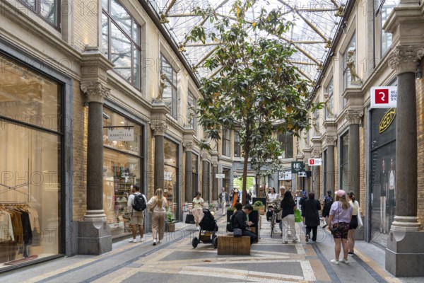 Copenhagen, Denmark, May 31, 2023: People in Jorcks Passage, a passageway and building with shops in the historic city centre, Europe
