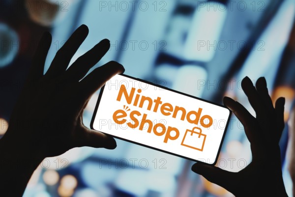 In this photo illustration, the Nintendo eShop logo is displayed on a smartphone screen