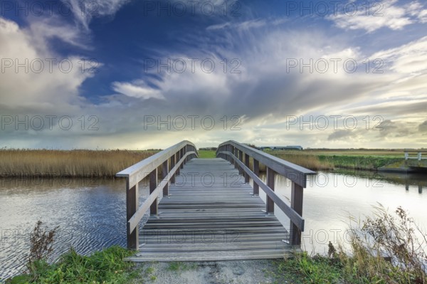 Wooden bridge via river and blue sky, Netherlands