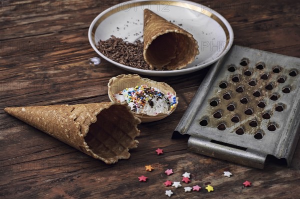 Ice cream decorated with sweet powder in the wafer on wooden background