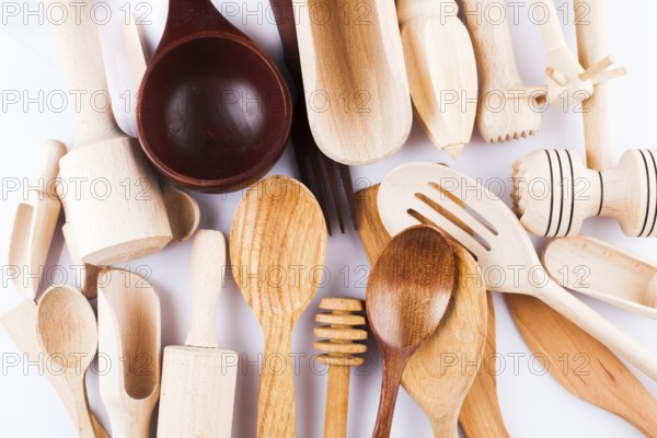 Assortment of wooden kitchen utensils on a white background