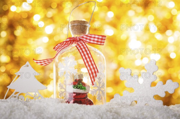 Christmas decor on the snow with gold bokeh background