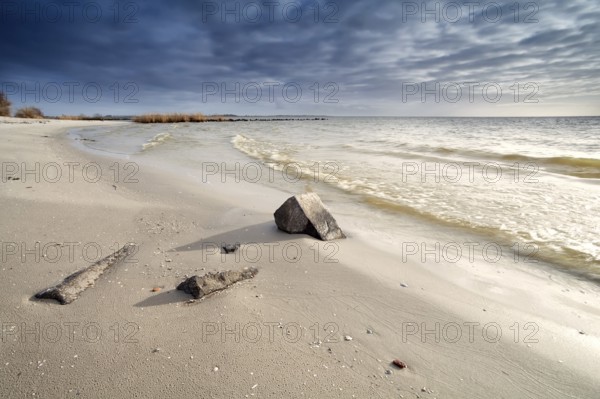 Deep sky cloudscape over sand beach on North sea