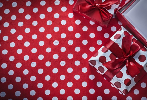 Present boxes on polka-dot red print background celebrations concept