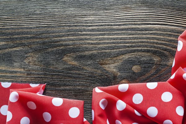 Red polka-dot table cloth on wood board top view