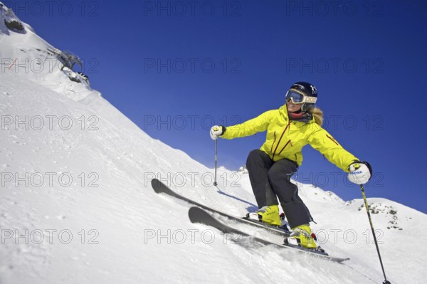 Skier in action, blonde woman, 25, 30, years, downhill skiing, Austria, Europe