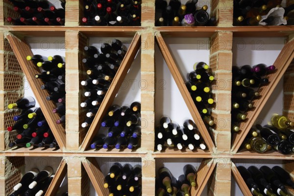 Wine Cellar from Mediterranean with bottles stacked in rows