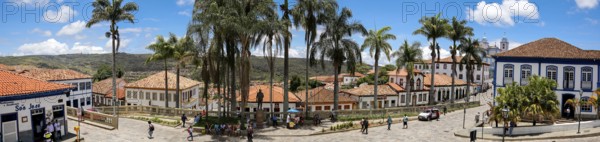 Panorama of traditional houses and palm tree lined street in historic center of Diamantina on a sunny day, Minas Gerais, Brazil, South America