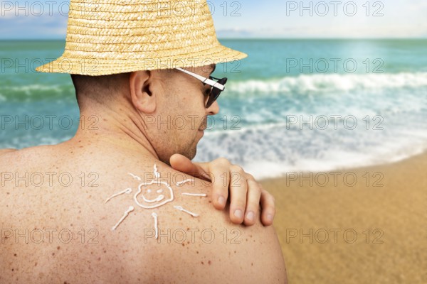 Middle aged caucasian male model applying sunscreen