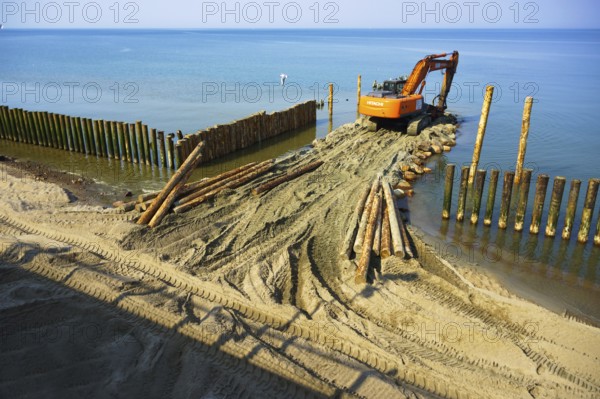 Construction equipment on the shore, the construction of breakwaters, coastal protection measures, Baltic sea, Russia, Kaliningrad region, March 28, 2020, Europe